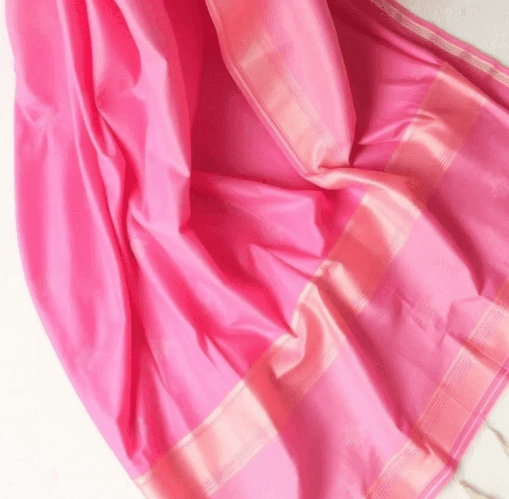 Vivid pink silk saree with champagne border and woven buttis