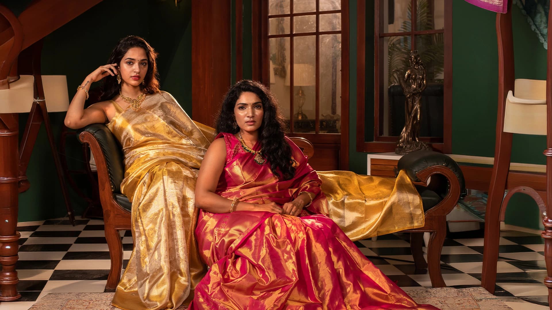 Woman in a maroon silk saree with gold zari in a heritage setting